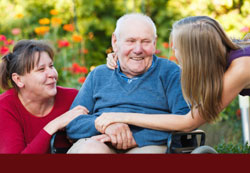 Infirm elder man smiling with family outside - click for "Guardianship & Conservatorship"