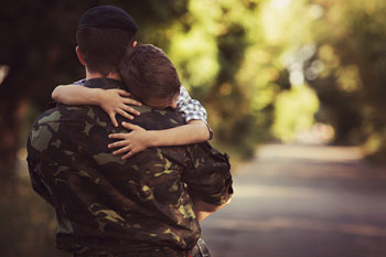 Man in military uniform hugging his son - Durable Power of Attorney