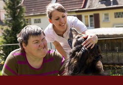 Person with special needs having fun outside with dog and caretaker or parent - click for "Special Needs Planning"